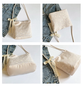 Detail showing floral canvas underarm bag with cream lace bow and leather base