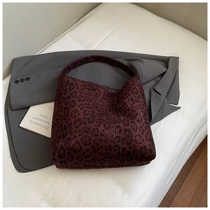 Close-up of leopard print tote bag on a grey suit jacket for a minimalist lifestyle look