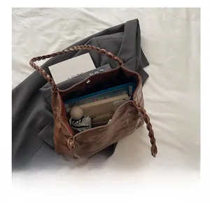 Top view of brown tote bag interior showing capacity for tablet, umbrella and wallet