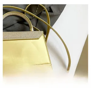 Close-up of golden leather handbag featuring shimmering rhinestone embellishments on flap