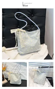 Detailed blue floral tote bag with white daisy patterns and lace bow decoration