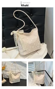 Detail of khaki floral checkered shoulder bag featuring elegant lace bow and sleek strap