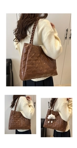 Brown tote bag with quilted bear pattern and plush cloud pendant detail view