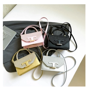 Detail of glitter flap texture and metallic T-buckle on stylish mini crossbody bags