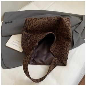 Detail of leopard print tote bag interior featuring smooth brown lining and spacious design