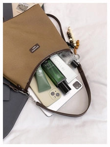 Top view of large brown canvas tote showing spacious interior for phone and cosmetics