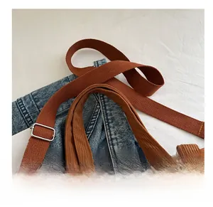 Close-up of adjustable strap buckle and corduroy texture on brown tote bag