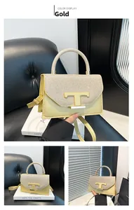 Detailed view of the gold sequin handbag with metal T-logo and elegant crossbody strap