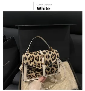 Detail of leopard print patchwork square handbag in a luxury black gift box display