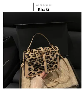 Close-up of leopard print shoulder bag with khaki PU flap and gold hardware detail
