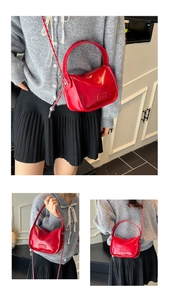 Detail of red glossy PU leather handbag with chain strap and Fashion logo plaque
