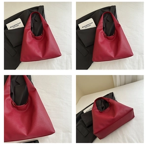 Close-up of deep red lychee texture leather on a large capacity minimalist tote bag