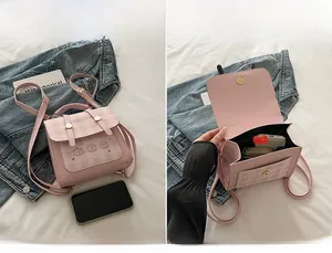 Detail showing the spacious pink plaid backpack main compartment and cute bear design