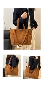 Detail view of large caramel corduroy tote bag showing handheld and crossbody styles
