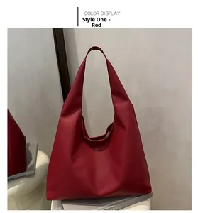 Close-up of red hobo tote bag with lychee pattern leather texture on display