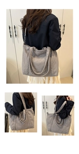 Macro shot of gray corduroy tote bag showing thick ribbed fabric and metal shoulder hook