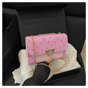 Pink cherry and bow print handbag with gold chain strap in a black gift box