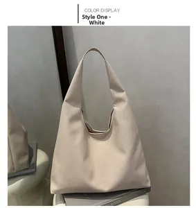 Detail shot of the creamy white large hobo bag featuring fine lychee leather texture