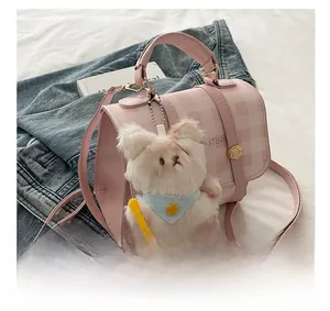Detail of pink plaid quilted handbag featuring a cute plush white animal charm