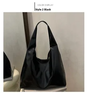 Detail of minimalist black PU leather tote bag in Style 2 showing the glossy textured finish