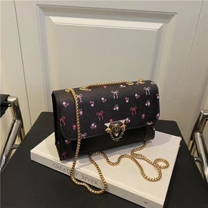 Fashionable black crossbody bag with pink floral patterns and gold chain strap