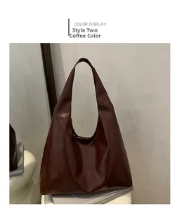 Detail of dark brown faux leather tote bag with smooth texture and soft drape finish