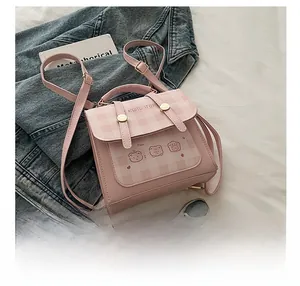 Pink checkered mini backpack with bear illustrations on a white textured background