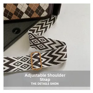 Close-up of adjustable woven shoulder strap with geometric pattern on checkered bag