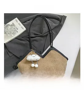 Detail of tan corduroy tote bag with V-shaped opening and white fluffy cloud charm pendant