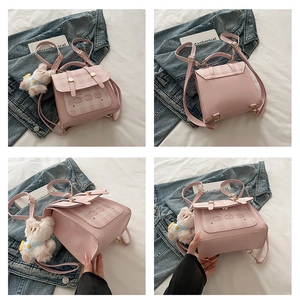 Pink mini backpack detail with plaid flap, gold hardware and plush bear charm