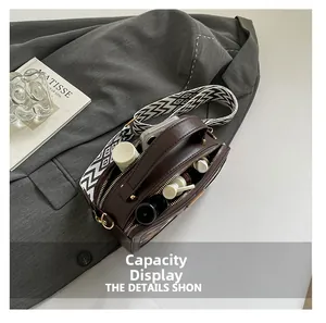 Detail view of the brown leather bag interior showing large capacity for phone and cosmetics