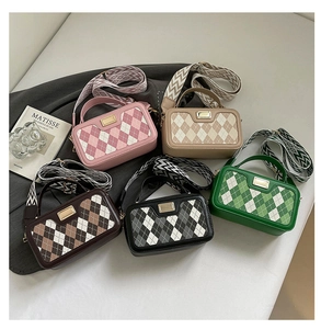 Collection of five quilted camera bags in pastel colors with wide patterned straps