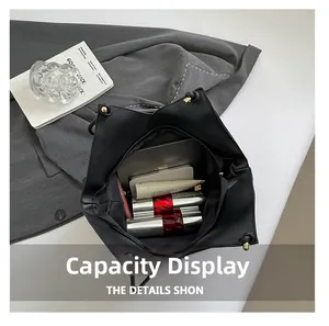 Top view of spacious black tote bag showing internal storage for phone and cosmetics