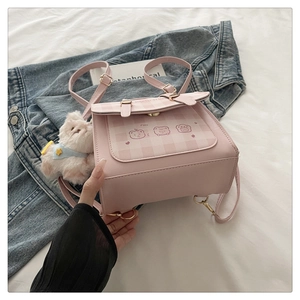 Pink checkered backpack with cute bear print and plush cat keychain detail