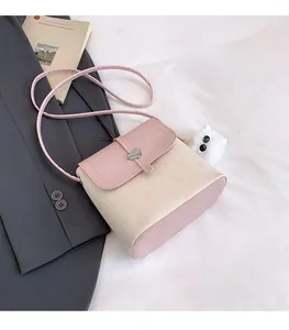 Detail of pink and white cat print crossbody bag with heart lock and kitten motif