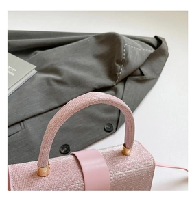 Vue détaillée du sac à main rose scintillant avec boucle en cuir et accents dorés