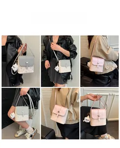 Mini bucket bag with heart buckle and plush dog pendant shown on a model outfit
