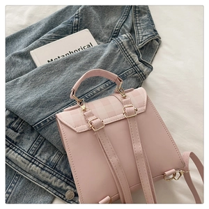 Detailed view of pink quilted PU leather mini backpack with checkered flap and gold hardware