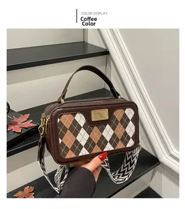 Detail of coffee rhombus pattern bag with gold metal buckle and wide strap