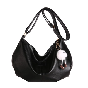 Minimalist black crescent hobo bag in glossy faux leather with a cute plush doll charm