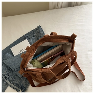 Brown corduroy tote bag showing large interior capacity for books and umbrella