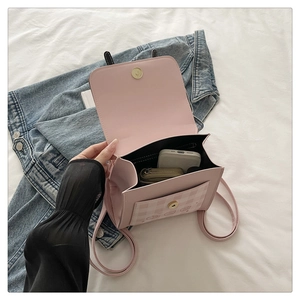 Detailed interior of small pink plaid backpack showing space for phone and power bank