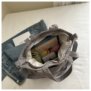Internal view of grey corduroy tote bag showing large capacity for books and umbrella