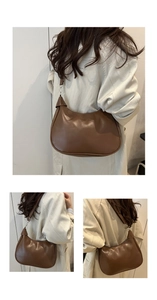 Close-up of brown leather crescent bag detailing smooth texture and silver metal hardware