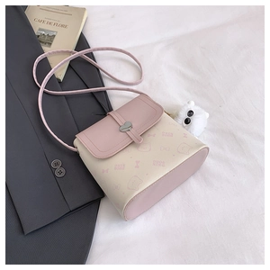 Close-up of contrast color crossbody bag with heart buckle and cat pattern print