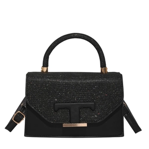 Elegant black crossbody bag featuring glitter flap and signature gold T-logo metal clasp