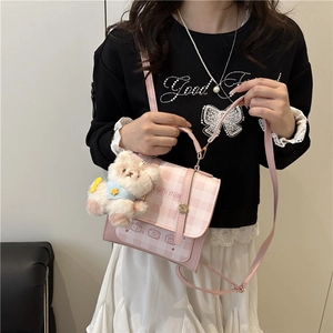 Chic pink plaid backpack with cute bear graphic and plush pendant shown on model