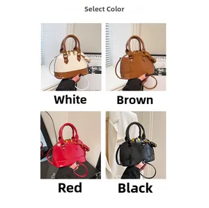 Detail view of shell-shaped crossbody bags in assorted colors with adjustable straps