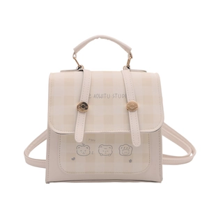 Minimalist beige checkered tote bag with cartoon bear and Aowitu Studio branding