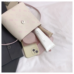 Capacity detail of mini beige crossbody bag showing phone and cosmetics storage